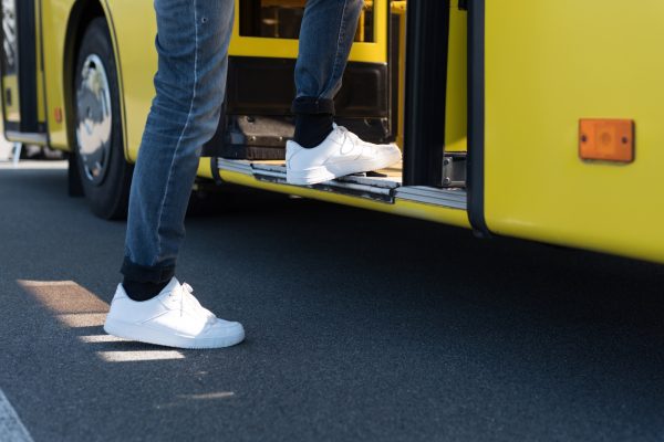 cropped shot of man entering city bus